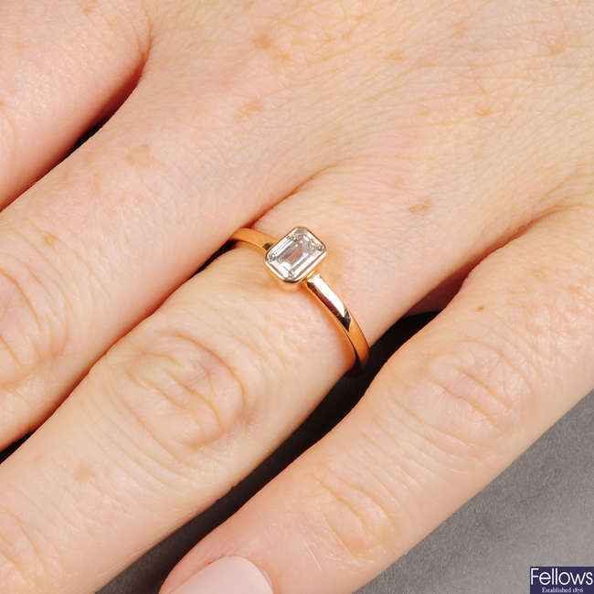 A rectangular-shape diamond single-stone ring.