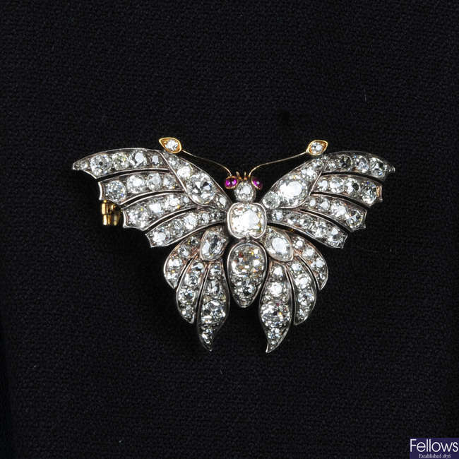 A late Victorian silver and gold, old-cut diamond butterfly brooch, with ruby eyes.