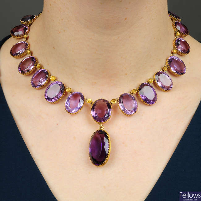 A late Victorian gold amethyst necklace, with floral spacers and detachable drop.