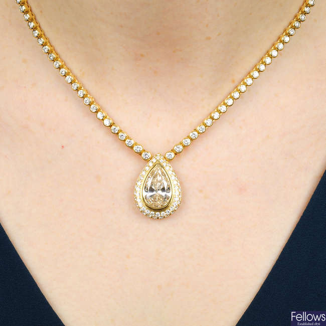 A pear-shape diamond and pave-set diamond cluster pendant, on brilliant-cut diamond collet necklace.