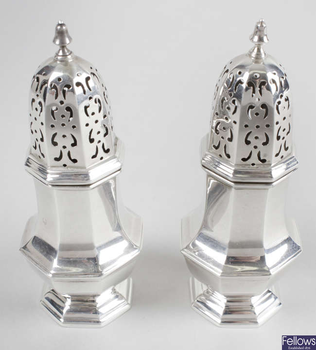 A pair of late Victorian silver pepper casters. 