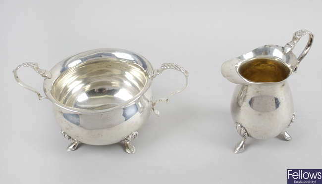 An Edwardian silver twin-handled sugar bowl & matching cream jug.