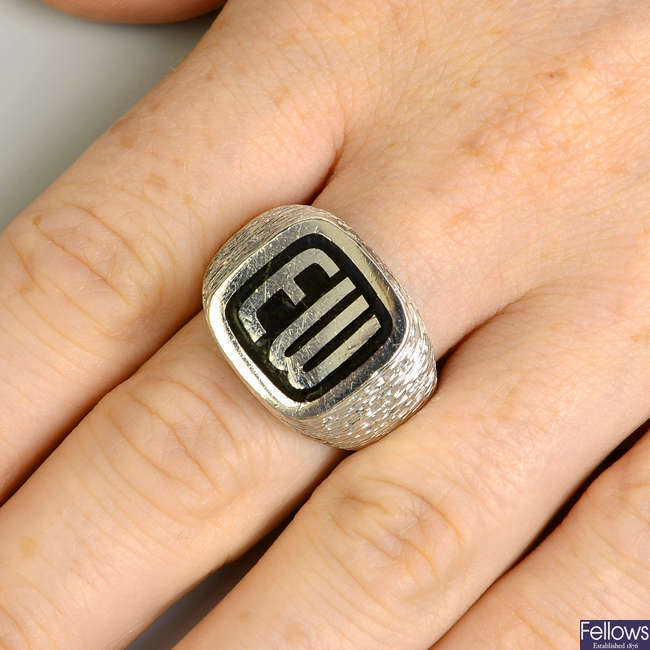A 1970s textured 18ct gold and black enamel monogrammed signet ring, by Kutchinsky.