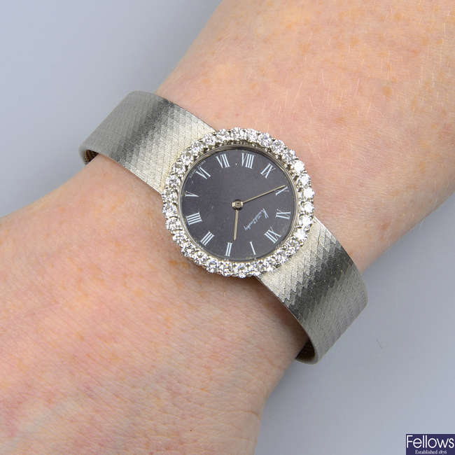 A lady's 1960s 18ct gold wrist watch, with black dial and brilliant-cut diamond bezel, by Kutchinsky.