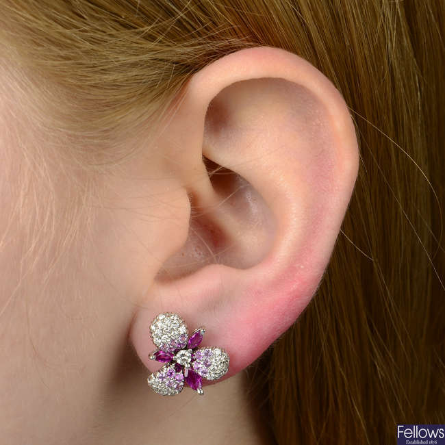 A pair of brilliant-cut diamond and pink sapphire floral earrings.