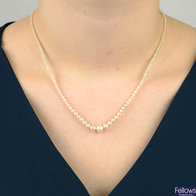 Natural saltwater pearl and seed pearl single-strand necklace, with sapphire and diamond cluster clasp.