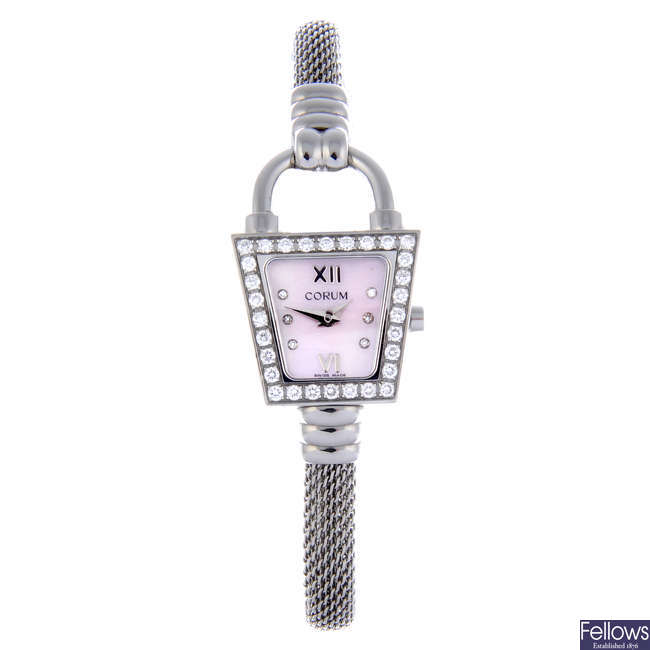 CORUM - a lady's stainless steel Padlock Trapeze bracelet watch.