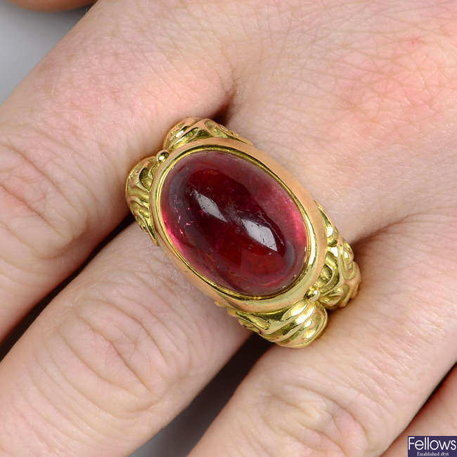 An 18ct gold pink tourmaline dress ring, with scrolling band, by Elizabeth Gage.
