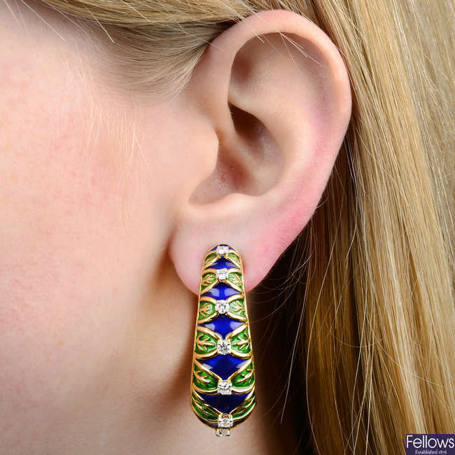 A pair of diamond and enamel hoop earrings.
