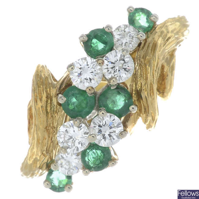 A brilliant-cut diamond and circular-shape emerald dress ring.