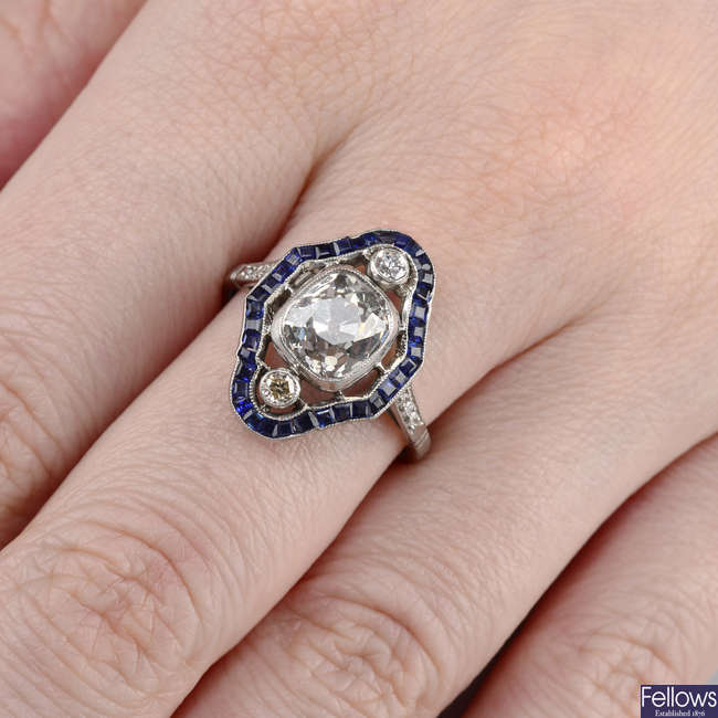 A cushion-shape diamond and sapphire cluster ring.