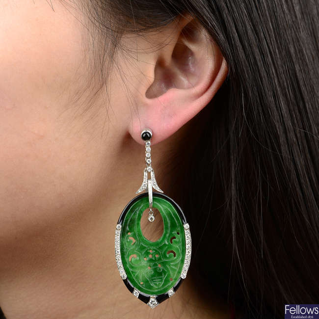 A pair of carved and pierced jade, brilliant-cut diamond, onyx and black enamel earrings.