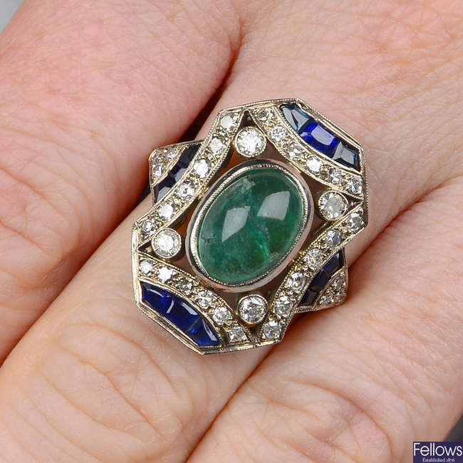 An emerald cabochon, sapphire and diamond dress ring.