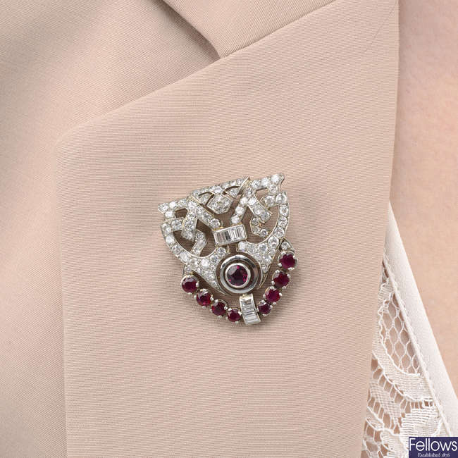 A mid 20th century vari-cut diamond and ruby dress clip.