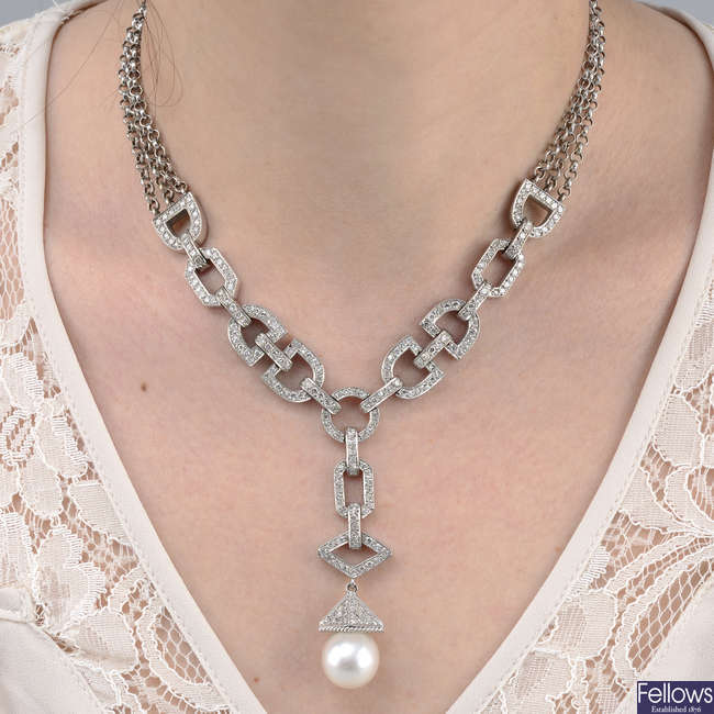 A circular-cut diamond and cultured pearl necklace.