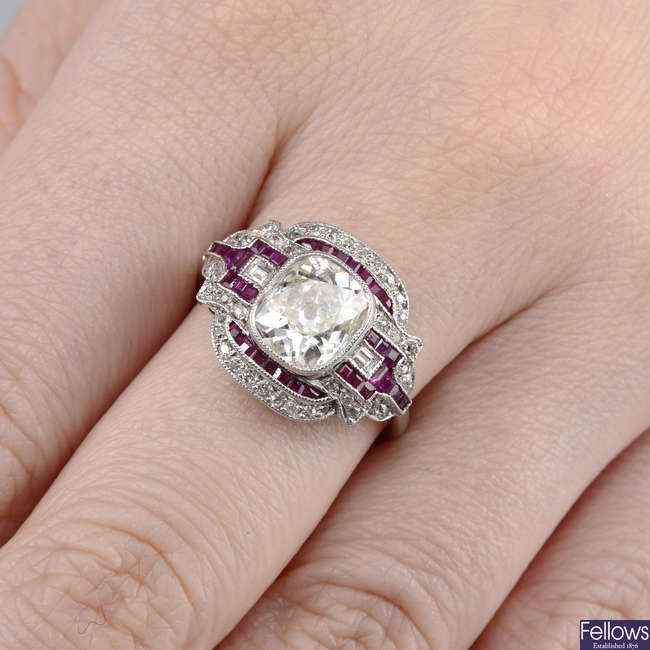 A cushion-shape diamond and ruby dress ring.