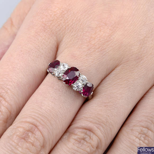 An early 20th century platinum, Thai ruby three-stone and circular-cut diamond ring.