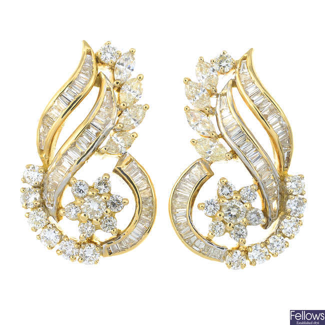 A pair of vari-cut diamond floral scroll earrings.
