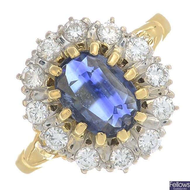 An 18ct gold oval-shape sapphire and brilliant-cut diamond cluster ring.