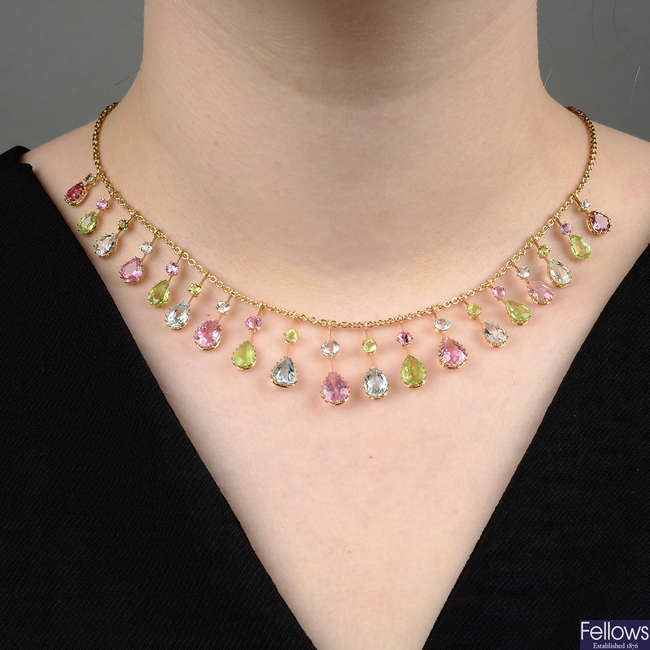 An Edwardian 15ct gold pink tourmaline, peridot and aquamarine harlequin fringe necklace.
