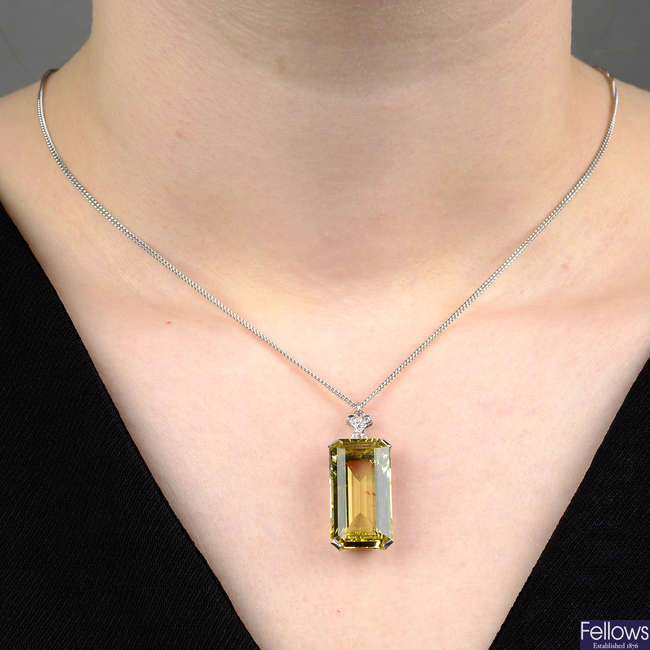 A heliodor beryl and diamond pendant, on chain.