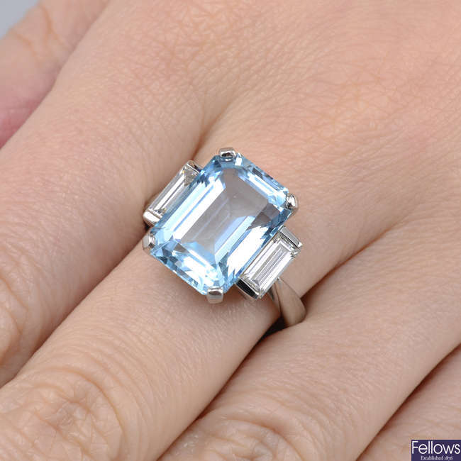 A platinum aquamarine and baguette-cut diamond three-stone ring.