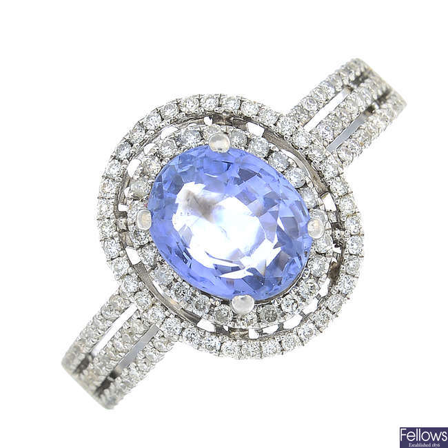 An oval-shape sapphire and brilliant-cut diamond cluster ring.
