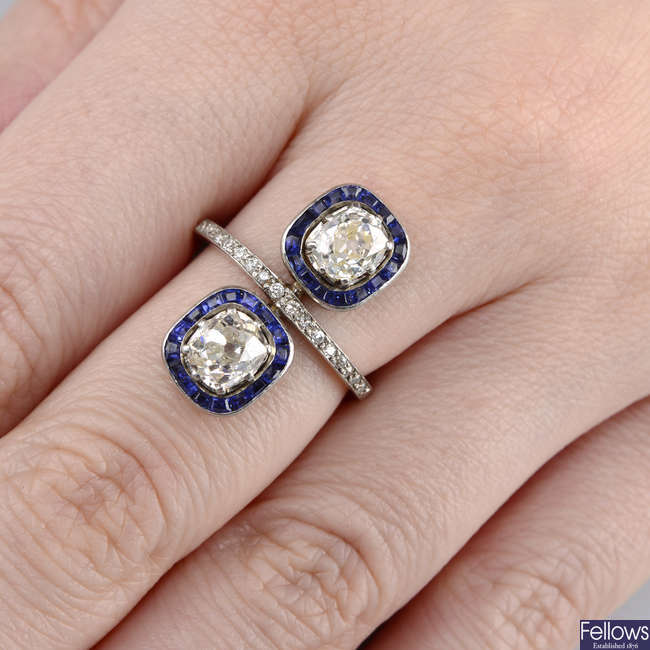 A mid 20th century old-cut diamond and calibre-cut sapphire twin cluster ring.