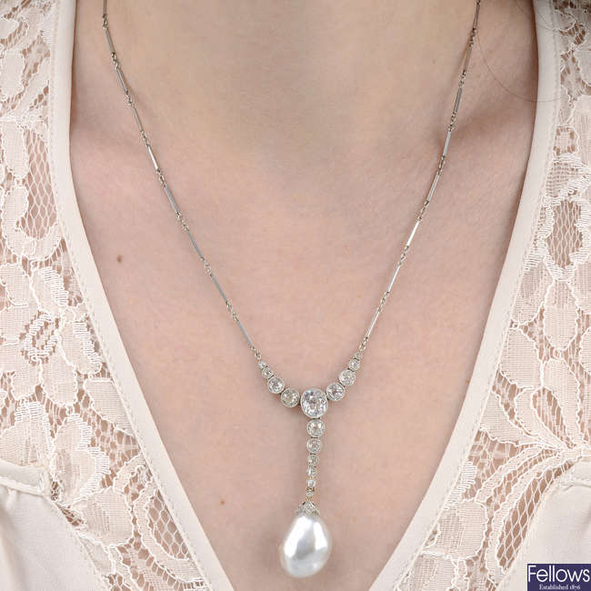 An early 20th century platinum natural saltwater baroque pearl and old-cut diamond necklace.