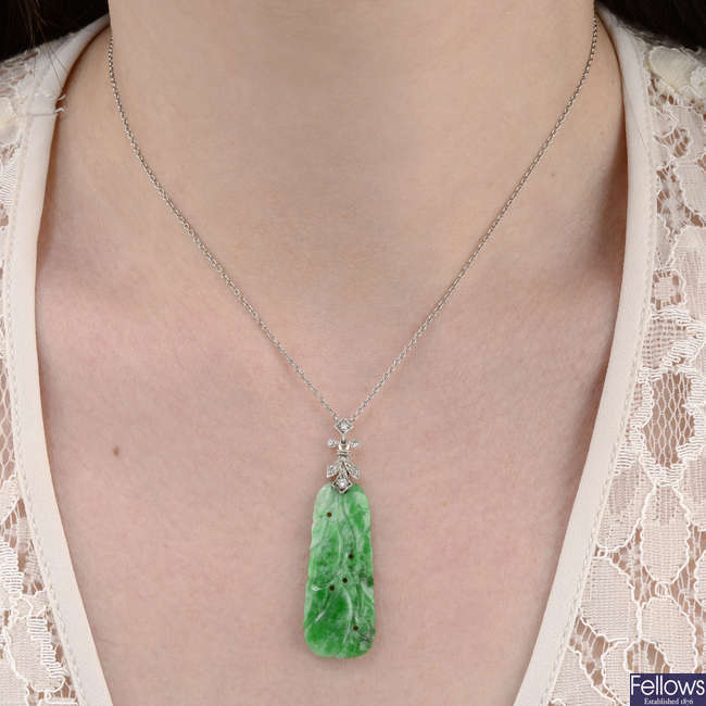 An early 20th century carved jadeite and vari-cut diamond pendant, with chain.