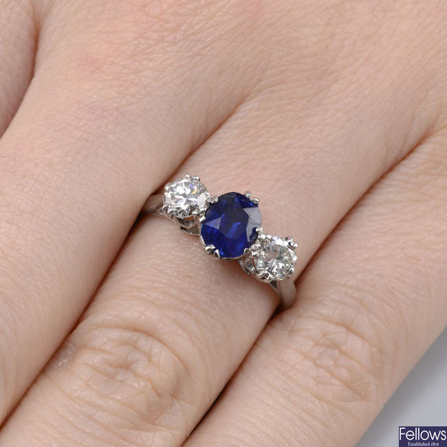 A sapphire and brilliant-cut diamond three-stone ring.