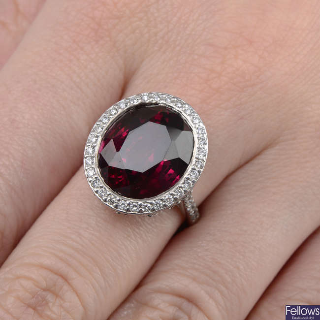 A garnet and brilliant-cut diamond cluster ring.
