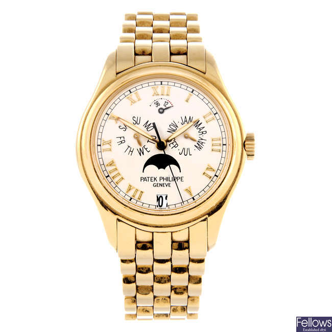 PATEK PHILIPPE - a gentleman's 18ct yellow gold Annual Calendar Moonphase bracelet watch.