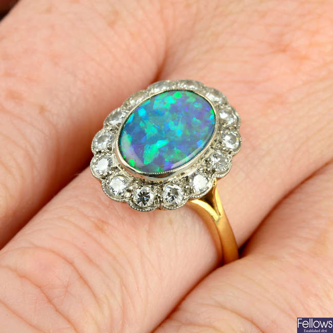 A mid 20th century 18ct gold black opal and brilliant-cut diamond cluster ring.