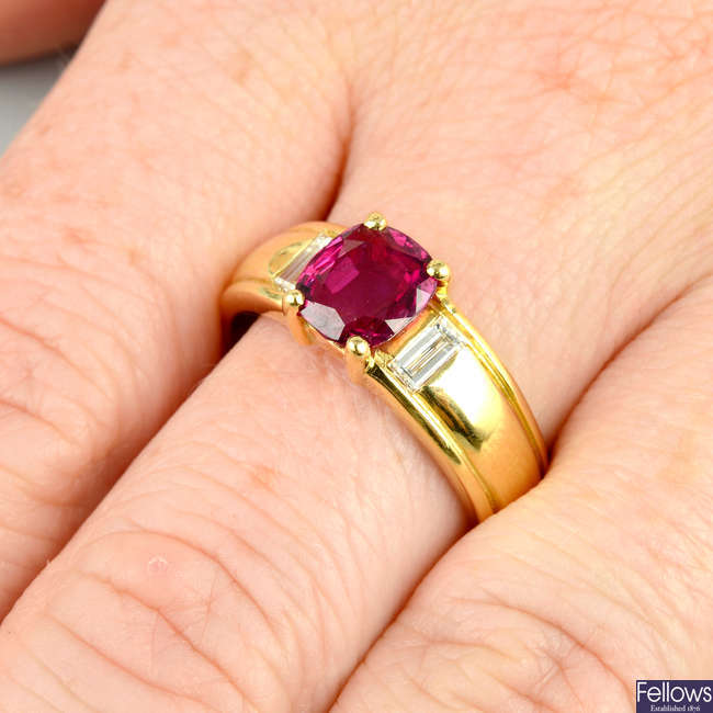 An 18ct gold Thai ruby single-stone ring, with baguette-cut diamond sides.