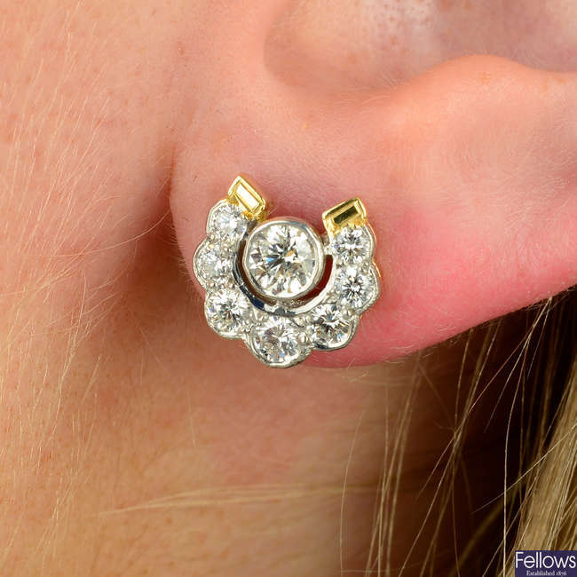 A pair of brilliant-cut diamond horseshoe earrings.