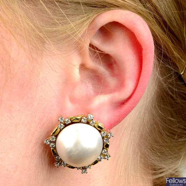 A pair of mabé pearl and diamond earrings.