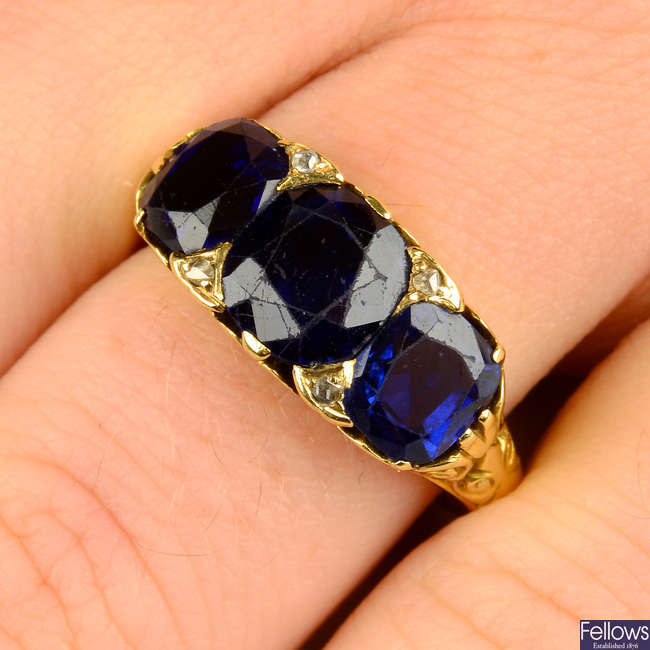 A late Victorian 18ct gold no-heat sapphire three-stone and diamond point accent ring.