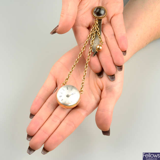 A mid to late 19th century 18ct gold and silver reverse-carved monogrammed spherical watch chatelaine, with key.