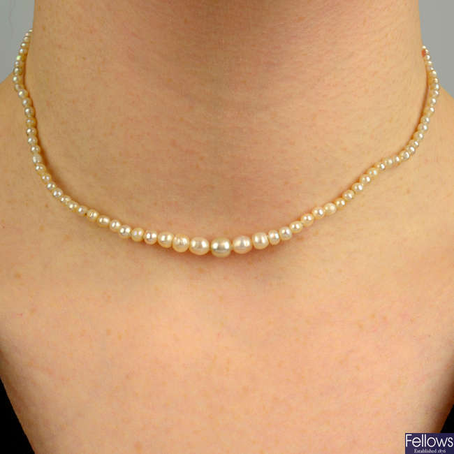 A graduated natural pearl single-strand necklace, with 19th century silver and gold old-cut diamond clasp.