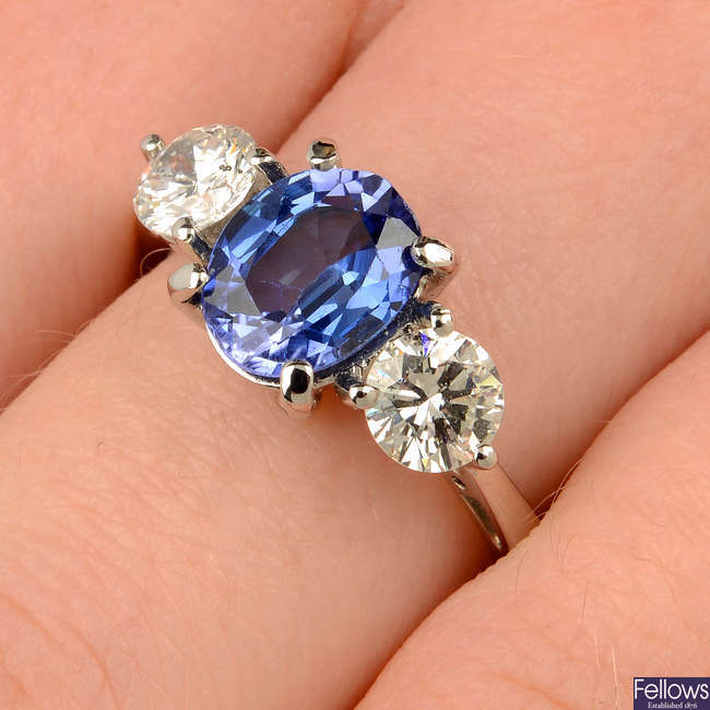 An 18ct gold sapphire and brilliant-cut diamond three-stone ring.