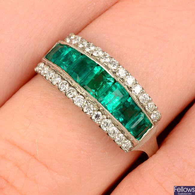 An emerald and diamond half eternity ring.