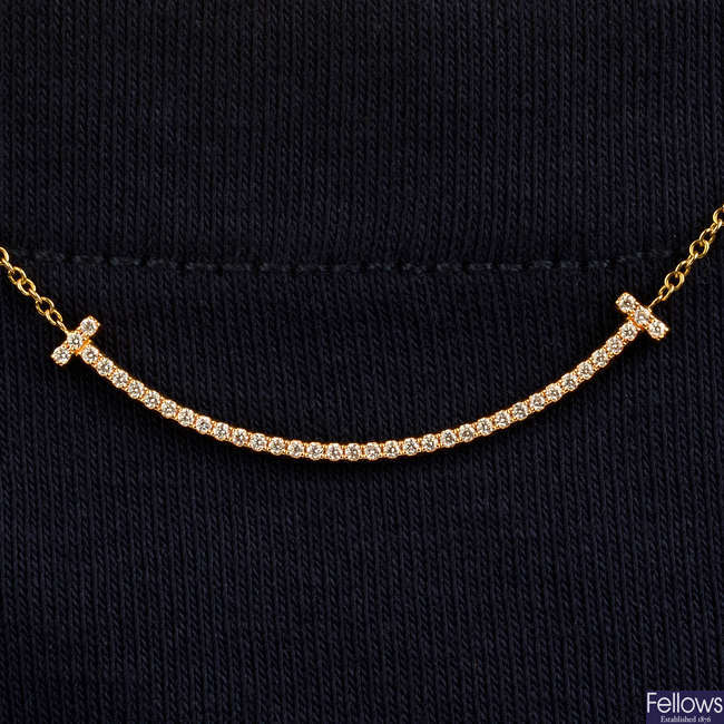 A diamond 'T Smile' pendant, by Tiffany & Co.
