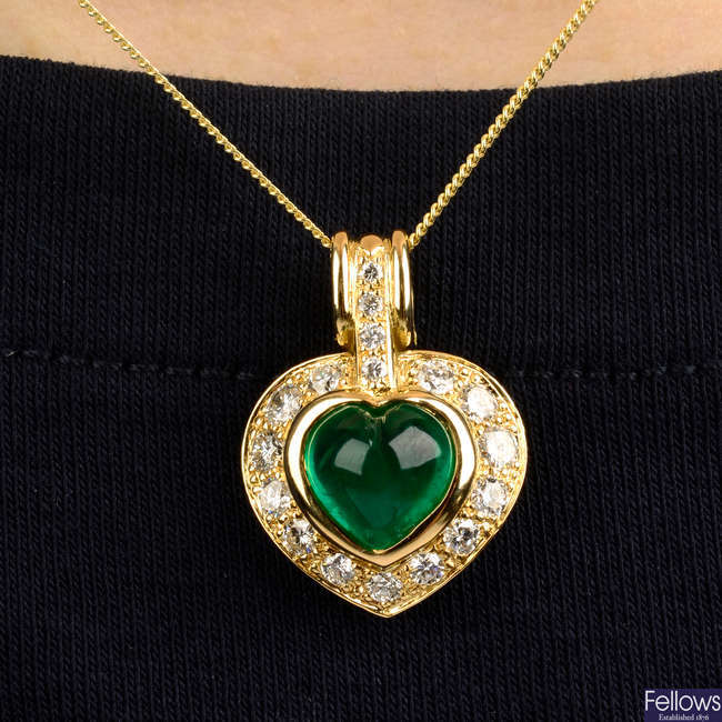 A heart-shape cabochon emerald and brilliant-cut diamond pendant.