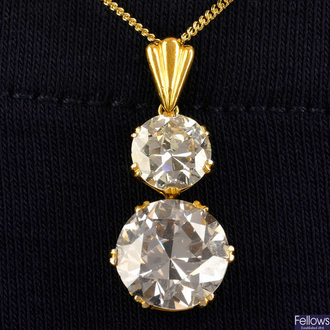 A circular-cut Light Pinkish Brown diamond and diamond graduated two-stone pendant, with 18ct gold chain.
