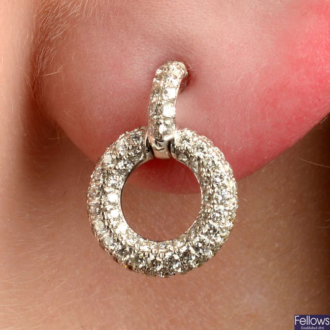 A pair of pavé-set diamond circular earrings.