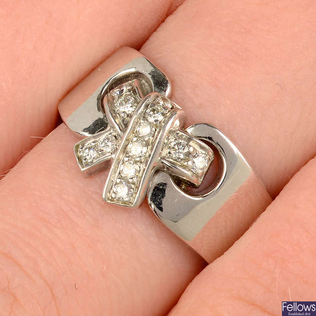 A pavé-set diamond bow ring, by Hermès.