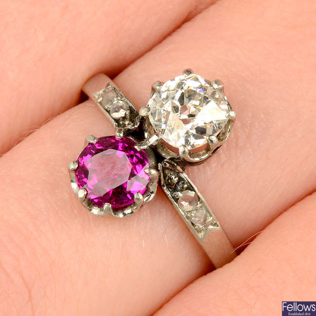An early 20th century platinum ruby and old-cut diamond two-stone ring, with rose-cut diamond shoulders.