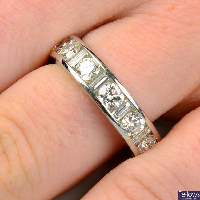 An 18ct gold brilliant-cut diamond full eternity ring, with baguette-cut diamond spacers.