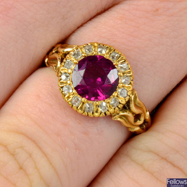 A late Victorian 18ct gold rhodolite garnet and old-cut diamond cluster ring, with floral shoulders and engraved band.